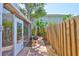 The backyard features lush tropical landscaping, a wooden fence, and a screened in porch at 3053 S Concordia Ave # A, Tampa, FL 33629