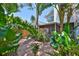 A secluded backyard surrounded by lush tropical landscaping offers a private oasis with a patio at 3053 S Concordia Ave # A, Tampa, FL 33629