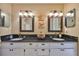 Bathroom with double sinks, granite countertops, and decorative artwork at 3053 S Concordia Ave # A, Tampa, FL 33629