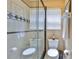 Bathroom featuring a glass-enclosed shower, neutral tile, and modern fixtures at 3053 S Concordia Ave # A, Tampa, FL 33629