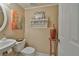 Well-decorated bathroom with a round mirror and decorative shelf with colorful accents at 3053 S Concordia Ave # A, Tampa, FL 33629