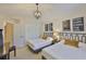 Bedroom with two twin beds, unique light fixture, and decor art at 3053 S Concordia Ave # A, Tampa, FL 33629