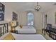 Bedroom with two twin beds, unique light fixture, and decor art at 3053 S Concordia Ave # A, Tampa, FL 33629