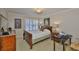 Cozy bedroom with a wood bed frame, bright window and a marble topped nightstand at 3053 S Concordia Ave # A, Tampa, FL 33629