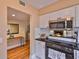 Well-lit kitchen featuring stainless steel appliances and sleek black countertops at 3053 S Concordia Ave # A, Tampa, FL 33629
