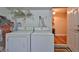 Functional laundry area equipped with a washer and dryer, opening to another room at 3053 S Concordia Ave # A, Tampa, FL 33629