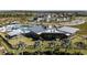 Aerial view of the community amenity center with a pool, covered seating, and ample parking at 31343 Pendleton Landing Cir, Wesley Chapel, FL 33545
