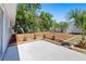 Well-maintained backyard with a patio, neatly landscaped flowerbeds, and mature trees at 3401 Truman Dr, Holiday, FL 34691
