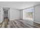 Neutral bedroom featuring wood floors, and a sliding glass door leading to the outdoors at 3401 Truman Dr, Holiday, FL 34691