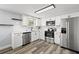 Updated kitchen with stainless steel appliances, modern fixtures, and new flooring at 3401 Truman Dr, Holiday, FL 34691
