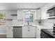 Bright kitchen featuring white cabinetry, stainless steel appliances, and a window above the sink at 3401 Truman Dr, Holiday, FL 34691