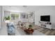 Open concept living and dining area featuring modern decor and updated flooring at 3401 Truman Dr, Holiday, FL 34691