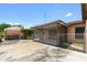 View of the screened in patio, detached garage, and concrete driveway in the backyard at 4208 W Flora St, Tampa, FL 33614