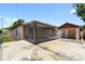Exterior view of the home with a screened-in patio and detached garage with extra parking space at 4208 W Flora St, Tampa, FL 33614