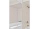 Bathroom featuring decorative tiled shower and tub combination and large vanity mirror at 4208 W Flora St, Tampa, FL 33614
