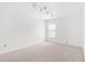 Carpeted room with track lighting and neutral walls with one window with blinds at 4208 W Flora St, Tampa, FL 33614