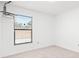 Carpeted room with window and neutral walls with one window with blinds at 4208 W Flora St, Tampa, FL 33614
