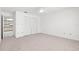 Carpeted bedroom features a ceiling fan and a closet with louvered doors at 4208 W Flora St, Tampa, FL 33614