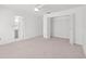 Bright bedroom with neutral carpet, ceiling fan, and open closet space at 4208 W Flora St, Tampa, FL 33614