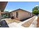 Exterior side view of the house showcasing the gravel path, screened-in patio, and AC unit at 4208 W Flora St, Tampa, FL 33614