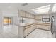 Well-lit kitchen featuring modern appliances, ample cabinet space, and a breakfast bar at 4208 W Flora St, Tampa, FL 33614