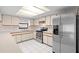 Classic kitchen design with stainless steel appliances, a bright window, and ample cabinet space at 4208 W Flora St, Tampa, FL 33614