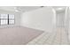 Spacious living room featuring neutral carpet, bright walls, and a window offering natural light at 4208 W Flora St, Tampa, FL 33614