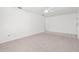 Clean living space with carpeted flooring, a ceiling fan, and a neutral color scheme at 4208 W Flora St, Tampa, FL 33614