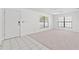 Bright living room featuring tile and carpet flooring, and two windows for natural light at 4208 W Flora St, Tampa, FL 33614