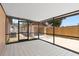 Spacious screened-in patio with tile flooring and view of the detached garage and fenced backyard at 4208 W Flora St, Tampa, FL 33614