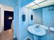 Elegant bathroom featuring a pedestal sink, large mirror, and stylish fixtures at 4360 Outrigger Ln, Tampa, FL 33615