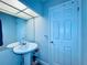 Elegant bathroom featuring a pedestal sink, large mirror, and stylish fixtures at 4360 Outrigger Ln, Tampa, FL 33615