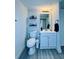 Bathroom with updated sink and vanity, shelving, and vinyl flooring at 4360 Outrigger Ln, Tampa, FL 33615