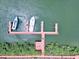 Aerial view of boat docks and deck on the water, surrounded by trees at 4360 Outrigger Ln, Tampa, FL 33615