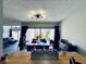Open dining room with modern light fixture and bright window view to outdoor patio at 4360 Outrigger Ln, Tampa, FL 33615