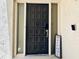 Elegant front door featuring a unique anchor knocker and welcome sign at 4360 Outrigger Ln, Tampa, FL 33615