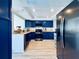 Modern kitchen featuring stylish blue cabinets, stainless steel appliances, and a granite countertop at 4360 Outrigger Ln, Tampa, FL 33615