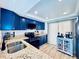Beautiful kitchen boasts blue cabinets, stainless appliances, modern fixtures, granite counters, and wood look floors at 4360 Outrigger Ln, Tampa, FL 33615