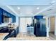 Modern kitchen with blue cabinets, granite countertops, and stainless steel appliances at 4360 Outrigger Ln, Tampa, FL 33615