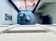 Open-concept living room featuring a comfortable blue sofa and stylish decor under a skylight at 4360 Outrigger Ln, Tampa, FL 33615