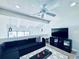 Upstairs living area with lots of light, a large sectional, and a home entertainment center at 4360 Outrigger Ln, Tampa, FL 33615
