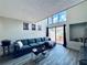 Bright living room boasts a modern sofa, high ceilings, stylish artwork, and a sliding glass door to the patio at 4360 Outrigger Ln, Tampa, FL 33615