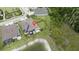 Aerial view of the home with solar panels, a screened porch, outdoor grill, and proximity to the pond at 4583 Barletta Ct, Wesley Chapel, FL 33543