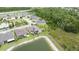Aerial view of the home showing a fenced yard, solar panels, pool, and adjacent pond at 4583 Barletta Ct, Wesley Chapel, FL 33543