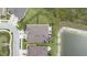 Aerial view of the home, roof, backyard, and proximity to the pond at 4583 Barletta Ct, Wesley Chapel, FL 33543