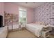 A bright and cheerful bedroom with butterfly-themed wallpaper and a window with shutters at 4583 Barletta Ct, Wesley Chapel, FL 33543