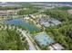 Aerial shot showcasing a community with a basketball court, tennis court, lake, and pool at 4583 Barletta Ct, Wesley Chapel, FL 33543