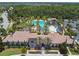 Aerial shot of the clubhouse with a refreshing community pool, waterslide, and seating areas, perfect for relaxation at 4583 Barletta Ct, Wesley Chapel, FL 33543