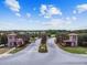 A grand entrance to the community with stone gatehouses, palm trees, and well-maintained landscaping at 4583 Barletta Ct, Wesley Chapel, FL 33543