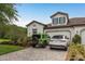 Exterior elevation of a two-story home featuring a three-car garage, and a paver driveway at 4583 Barletta Ct, Wesley Chapel, FL 33543